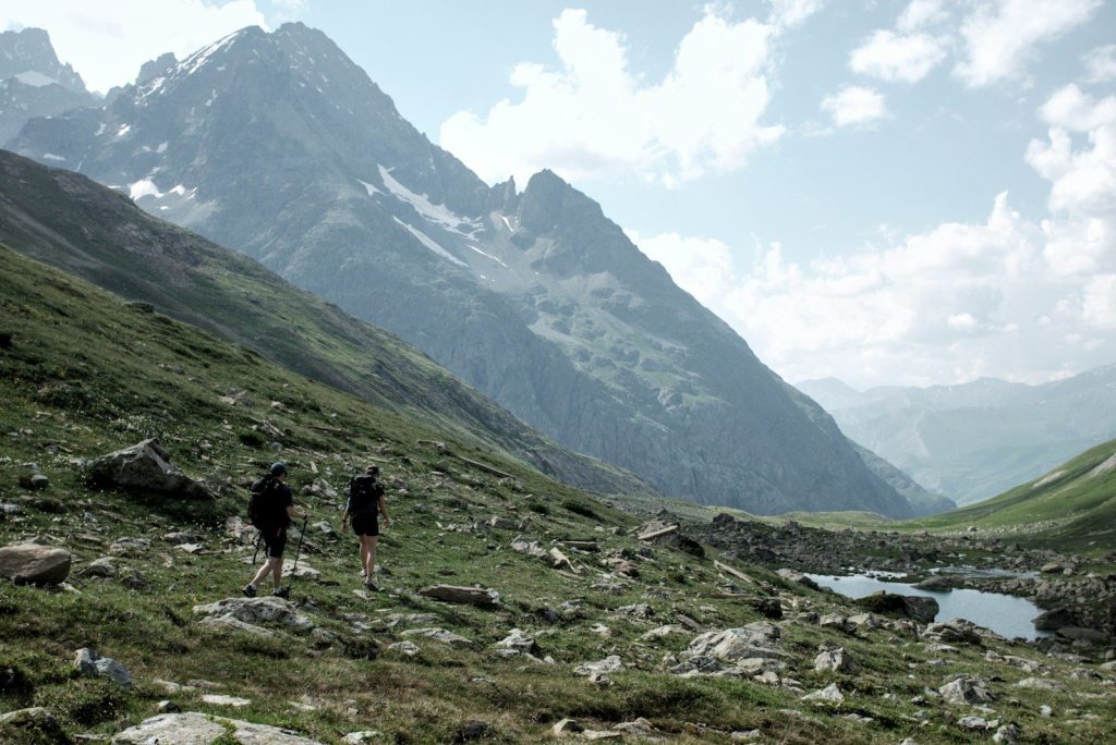 Hikers traverse a scenic mountain landscape