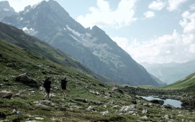 Hikers traverse a scenic mountain landscape